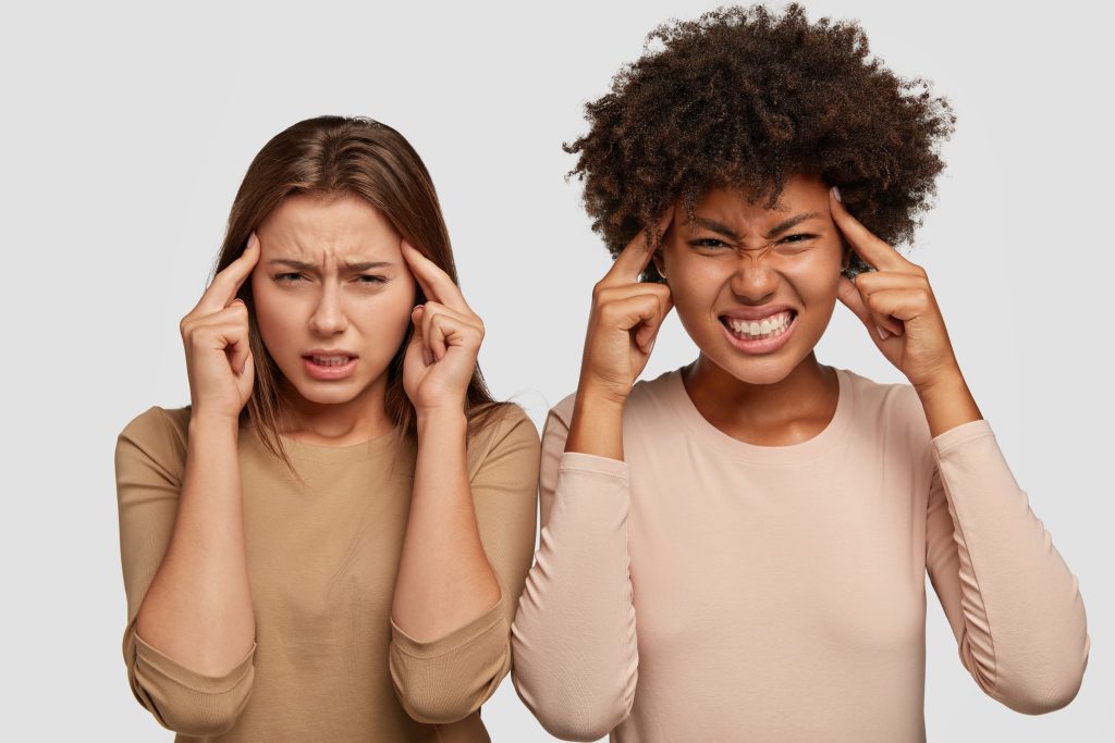 stressful girlfriends posing against white wall