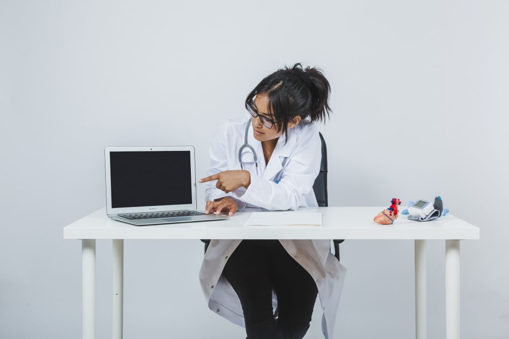 doctor showing laptop s screen